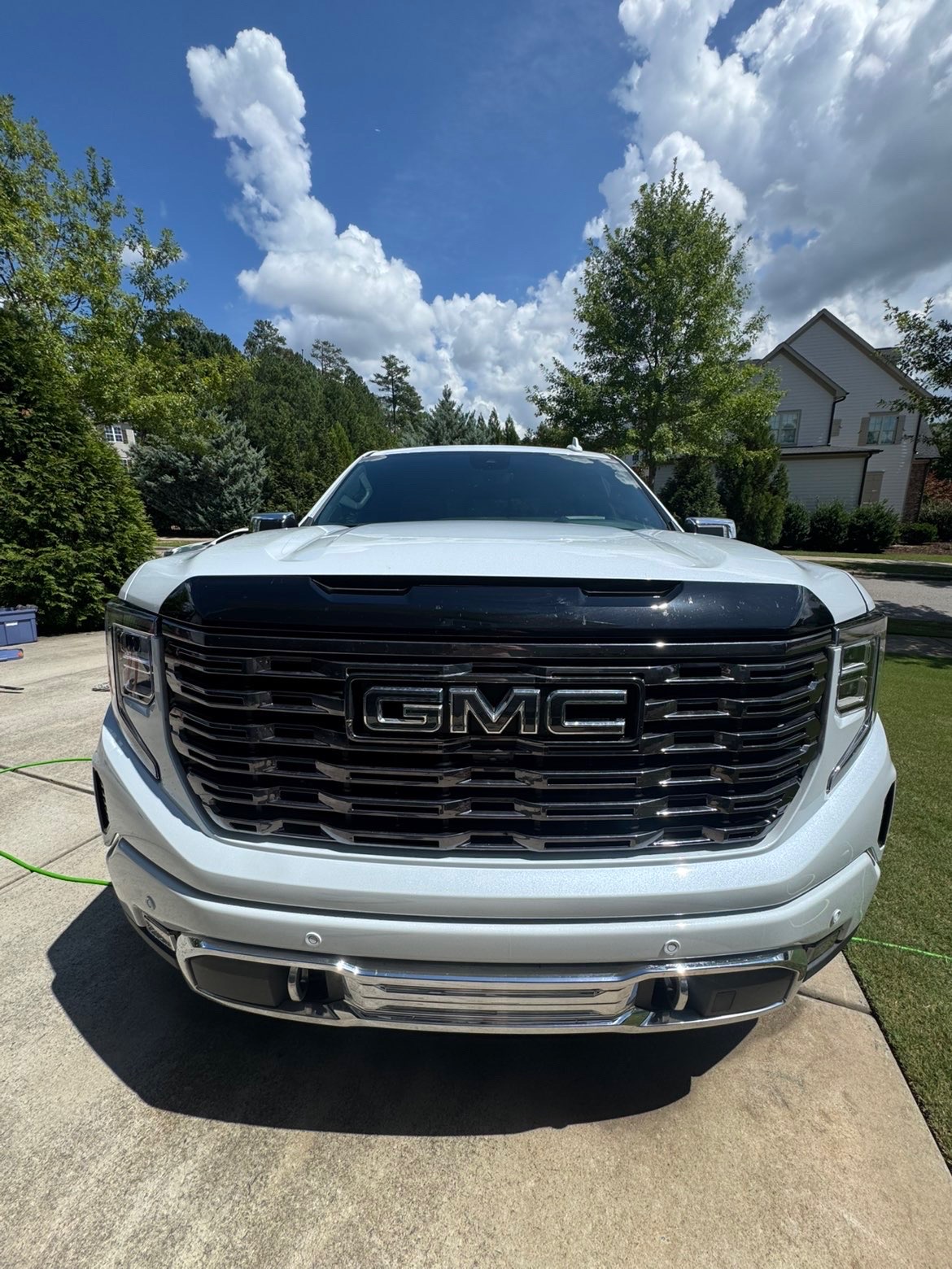 GMC truck front grille clean and glossy after a fresh wash