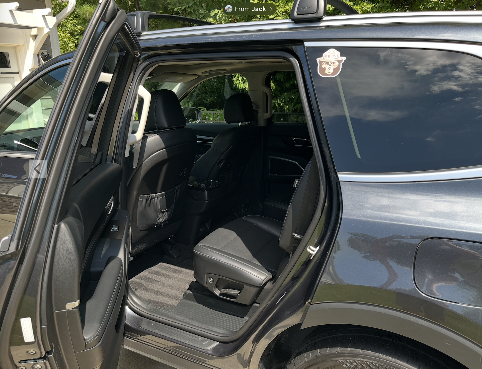 Freshly detailed Kia SUV rear seats and clean carpet with the door open