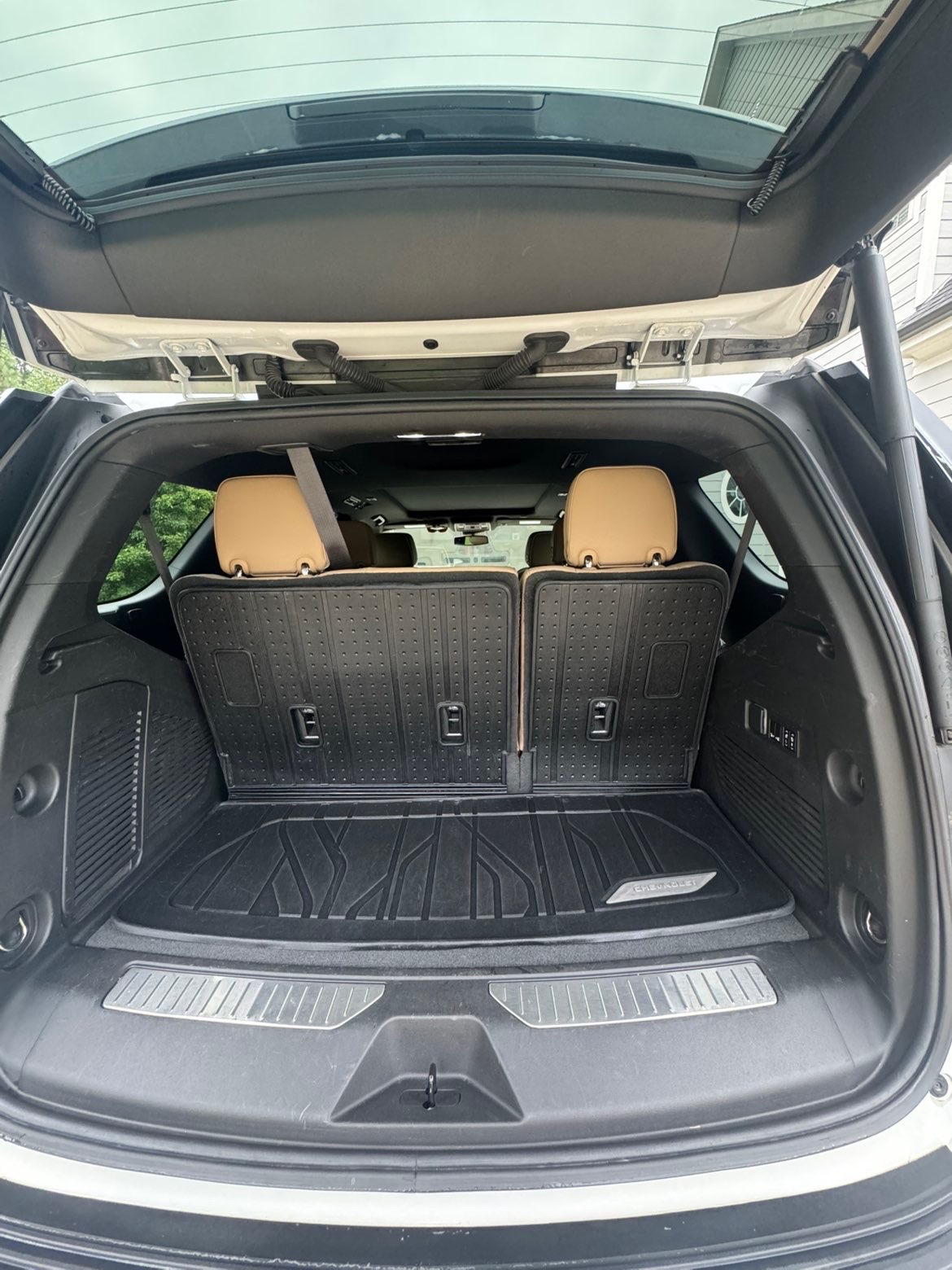 Detailed SUV cargo area with folded rear seats and clean cargo liner