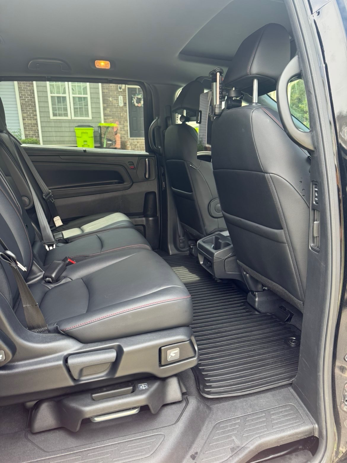 Detailed truck rear interior with clean black leather seats and spotless rubber floor liners