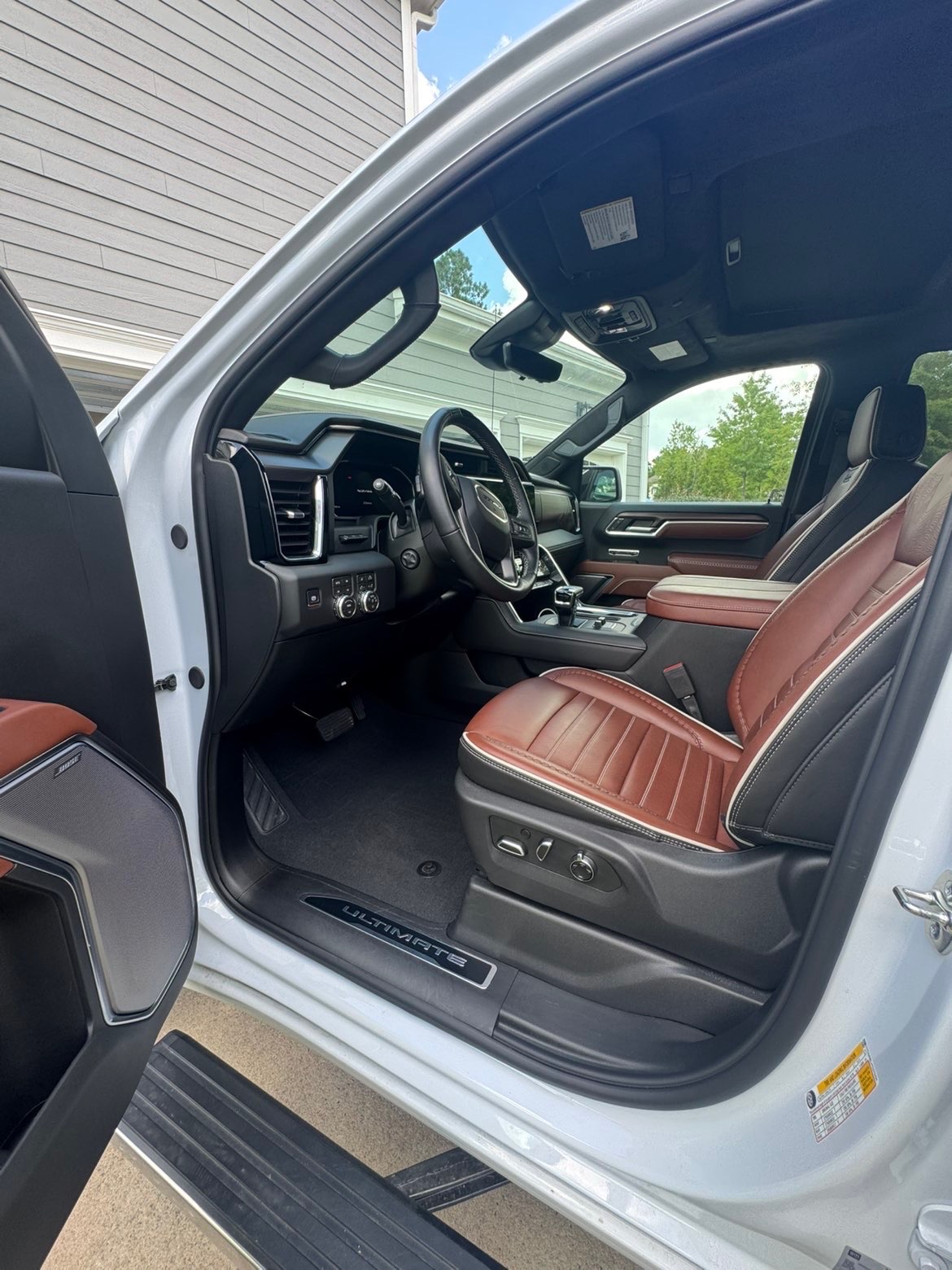 Detailed truck front interior with clean reddish-brown leather seats and spotless floor mats